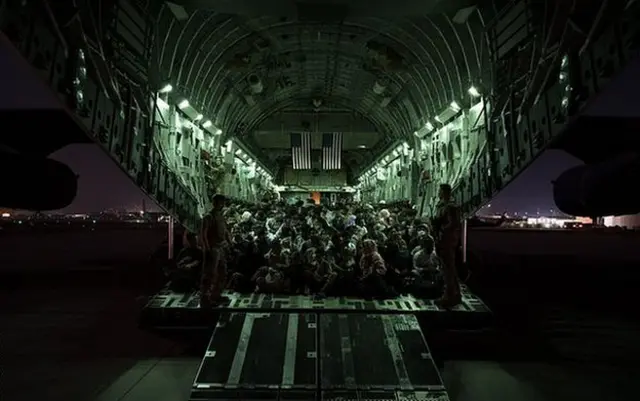 An American military plane prepares to depart Kabul airport carrying evacuees, on 21 August