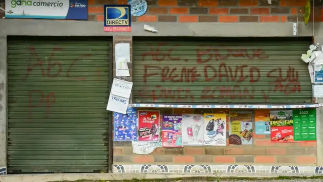 Una tienda con un grafiti alusivo a las AGC.
