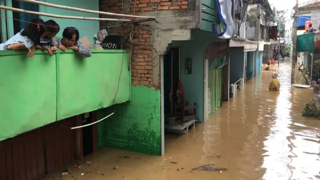 Nenek Muneh bersama dua cucunya yang enggan beranjak dari rumahnya