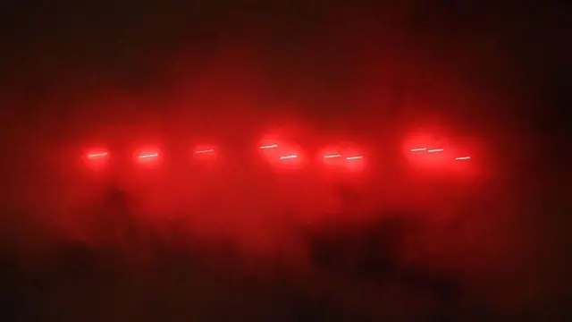 Żarzące się czerwone smugowe pociski wśród unoszącego się dymu, gdy ukraińska obrona powietrzna ostrzeliwuje rosyjskie drony i rakiety nad Kijowem 25 listopada.