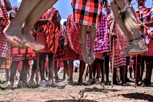 Men from the Kenyan Maasai tribe jump in unison during the rites.