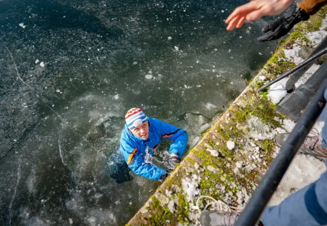 Emergency services help skaters to get off the ice at the Hofvijver in The Hague, The Netherlands, 12 February 2021.