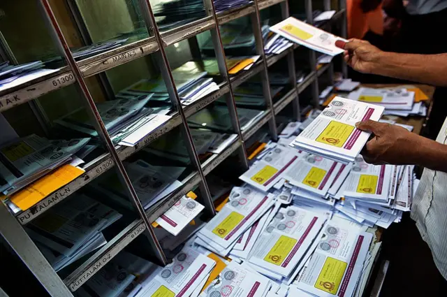 Sri Lankan postal service's employees sort letters at the General Post Office in Colombo on October 3, 2013