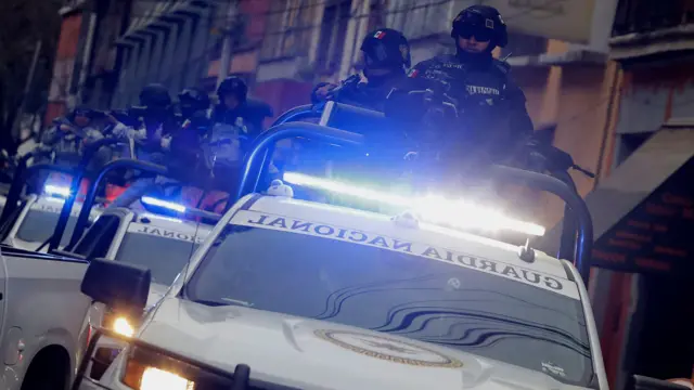 National Guard convoy in Mexico City on 22 February 2026, escorts a Rhino, an armoured tactical vehicle used for high-impact operations and critical security situations, after federal forces killed 'El Mencho'. Armed forces with protective helmets stand in open-topped vehicles holding machine guns. Photo by Gerardo Vieyra