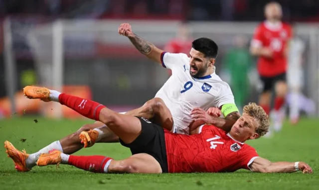 Leopold Querfeld tacle l'attaquant serbe Aleksandar Mitrovic