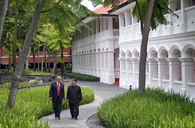 U.S. President Donald Trump walks with North Korean leader Kim Jong Un at the Capella Hotel on Sentosa island in Singapore June 12, 2018. Kevin Lim/The Straits Times via REUTERS ATTENTION EDITORS