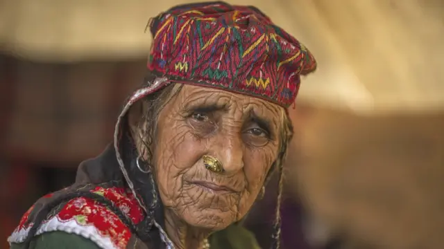 An old shepherd poses for on the outskirts of Srinagar