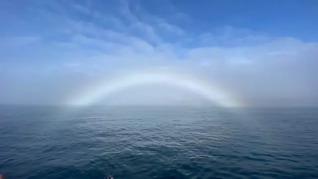 A fogbow spotted in St Martin's, Isles of Scilly. Also known as a white rainbow, cloud bow or ghost rainbow, the arc is formed when sunlight interacts with small water droplets contained in fog, mist or cloud. Photo by Weather Watcher CocoTik.