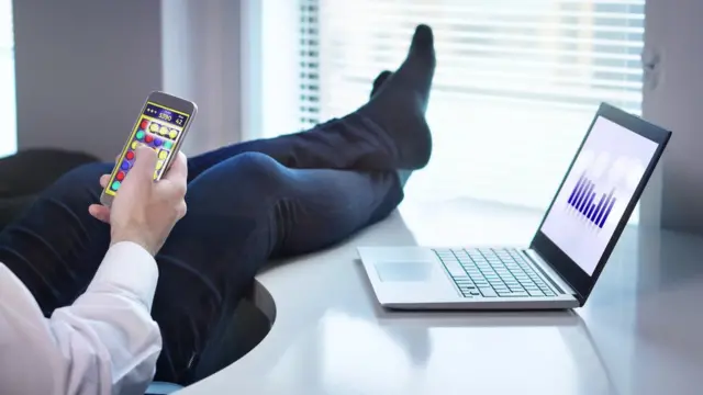 Man looking at phone while at work