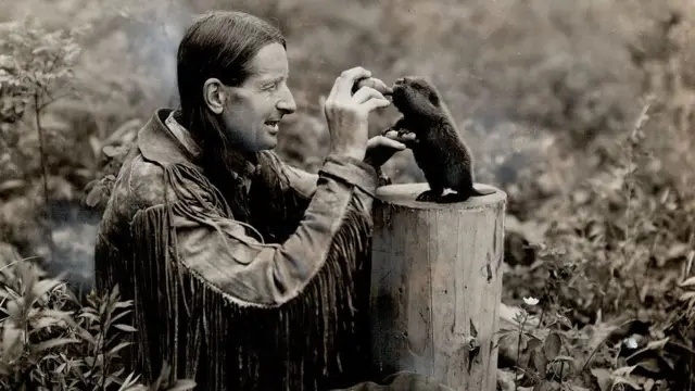 Foto do polêmico naturalista grey Owl dando mamadeira a um bebê castor