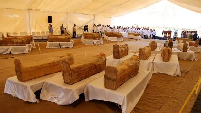Archaeologists stand near painted ancient coffins discovered at Asasif necropolis, in Luxor, Egypt, 19 October 2019