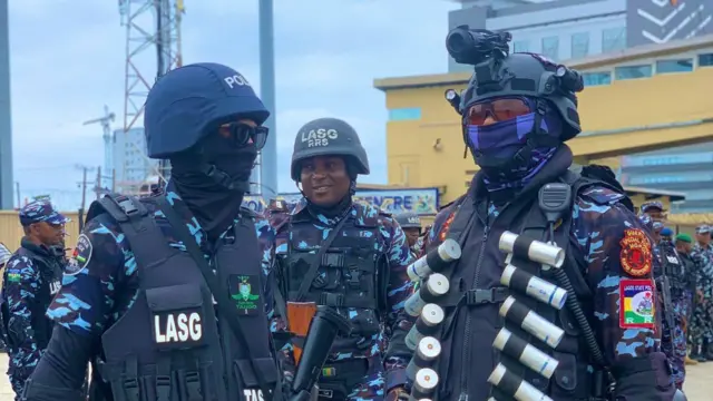 Di police carry long convoy wit armed officers dey patrol som part of di state