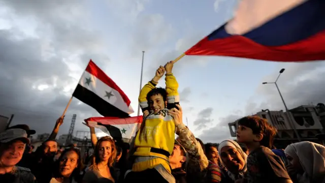 Жители Хомса на улицах после того, как боевики покинуи город