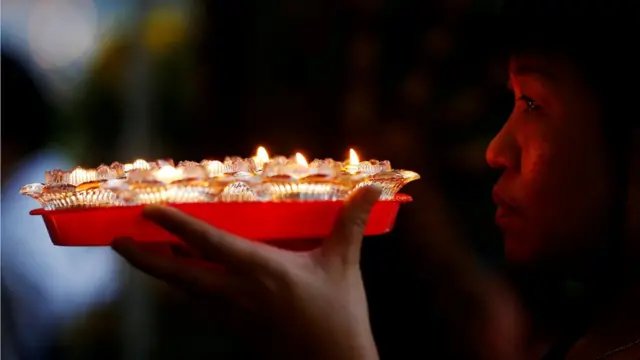 A devotee prays ahead of Vesak Day at Kong Meng San Phor Kark See Monastery in Singapore May 28, 2018