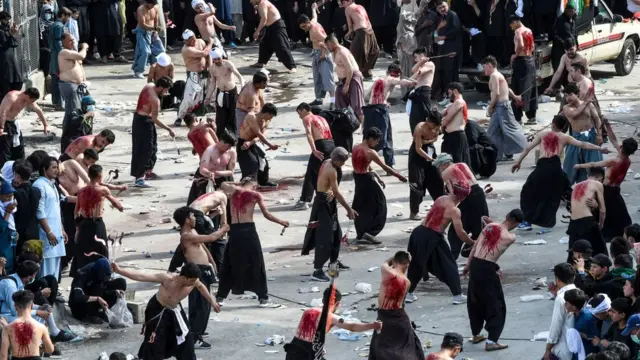 Shiite Muslims flagellate themselves for an Ashura procession during the month of Muharram in Quetta on August 30, 2020. - Ashura is a period of mourning for Shiite Muslims during Muharram commemorations to mark the seven-century martyrdom of Prophet Mohammad's grandson Imam Hussein who was killed in battle in Karbala in Iraq 680 AD.