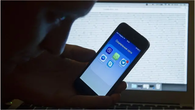 A mobile phone showing social media apps in Russian