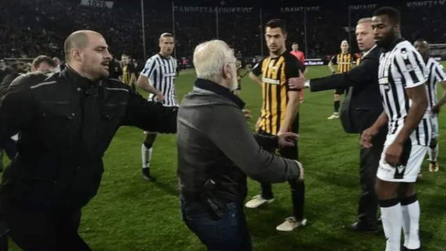Ivan Savvidis storms the pitch with a gun in its holster