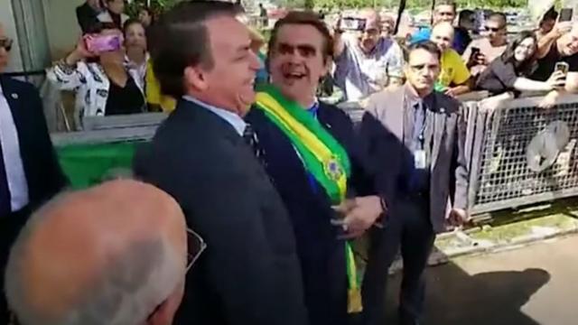 Bolsonaro ao lado do humorista Carioca, que tentou distribuir bananas a jornalistas em frente ao Palácio da Alvorada