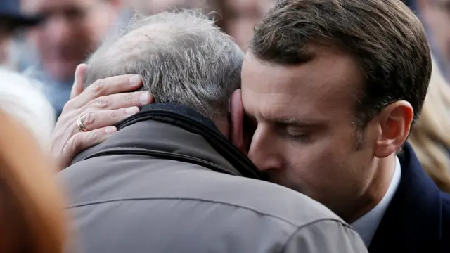 French President Emmanuel Macron gives his condolences to relatives of victims near the Bataclan concert venue during a ceremony marking the second anniversary of the Paris attacks of November 2015 in which 130 people were killed, in Paris, France, 13 November 2017