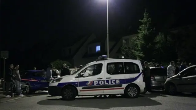 The suspect attacked the policeman before entering his house and taking his partner and child hostage, witnesses said