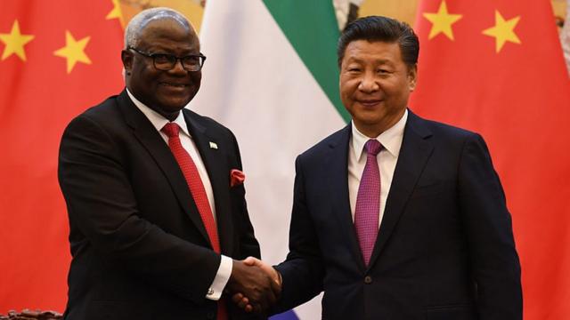 Former Sierra Leone President Ernest Bai Koroma (L) and Chinese President Xi Jinping shake hands during a signing ceremony in Beijing's Great Hall of the People on December 1, 2016.
