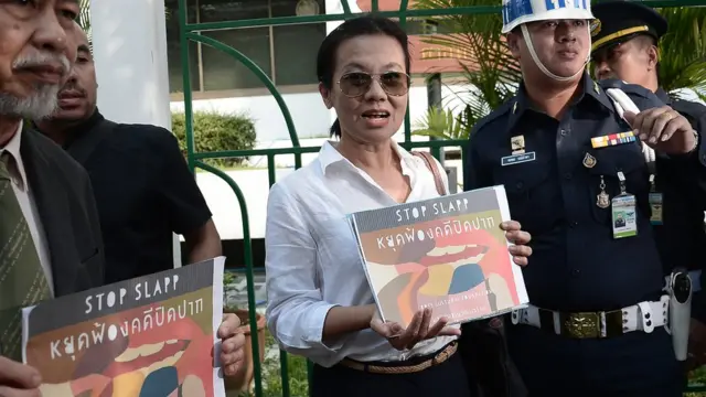 ตัวแทนจากมูลนิธิผสานวัฒนธรรมชูป้ายคัดค้านการดำเนินคดีเกี่ยวกับเสรีภาพในแสดงความคิดเห็น ซึ่งวันนี้ (17 ม.ค.) เดินทางมาให้กำลังใจ ส.ศิวรักษ์