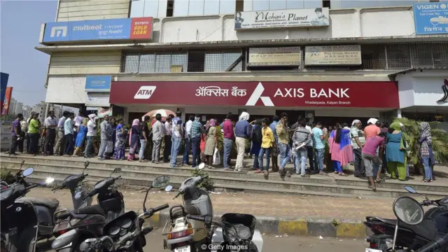 Some denominations of Indian bank notes were discontinued in 2016 leading to long queues of people waiting to withdraw money (Credit: Getty Images)