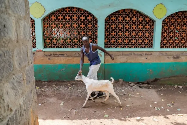 A man leads a goat to be slaughtered during Eid al-Adha in Nairobi, Kenya, on 20 July.
