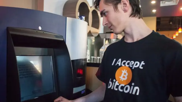 Gabriel Scheare uses the world's first bitcoin ATM on October 29, 2013 in Vancouver, British Columbia