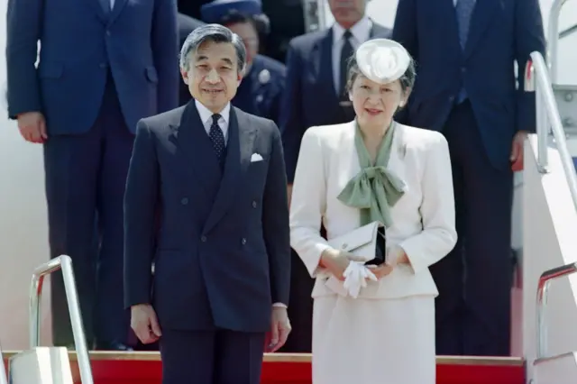 Japanese Empress Michiko (R) and Emperor Akihito bow to wellwishers as they arrive at Okinawa's Naha airport on April 23, 1993 for a five-day visit. Akihito is the first Japanese Emperor to tour Okinawa