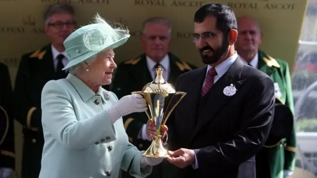 Queen Elizabeth II presents the Gold Cup to Sheikh Mohammed Al Maktoum head of Godolphin following Colour Vision"s victory during day three of the 2012 Royal Ascot