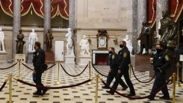 Police in the US Capitol building, the day after a deadly riot (7 Jan)
