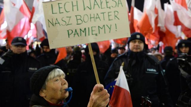 A demonstrator hold banner written: Lech Walesa is still our hero