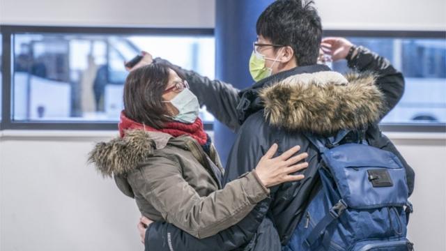 Tourists wearing face masks arrive to Lapland at Rovaniemi airport in Rovaniemi, Finland, 01 February 2020