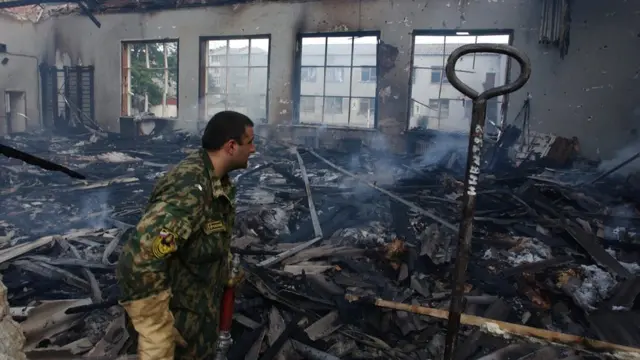 A fireman investigates a gym during the rescue operation at Beslan school, North Ossetia