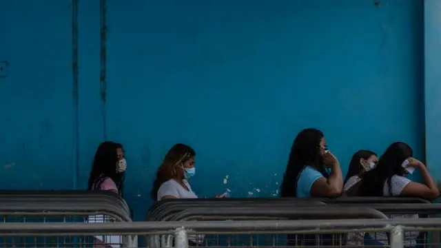 outside the gate where family members queue to pass letters and gifts to their loved ones inside