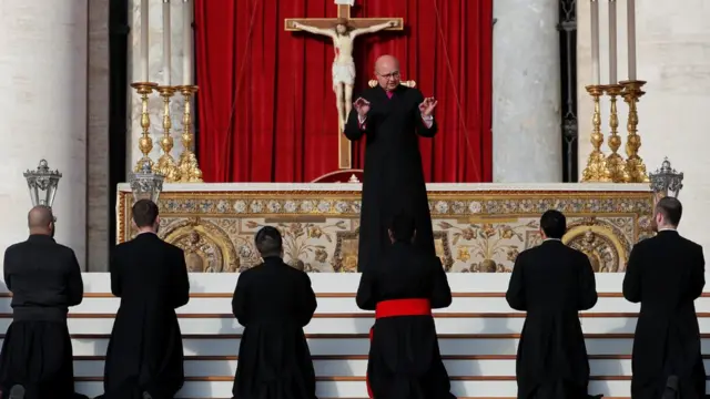 A priest giving instructions at the Vatican