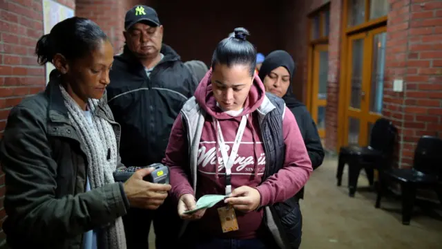 People queuing to vote