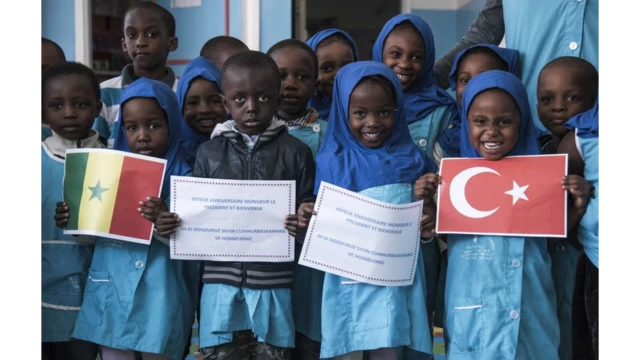 Children at a school in Senegal welcome President Erdogan with a picture of the Turkish flag during his 2018 visit to the country