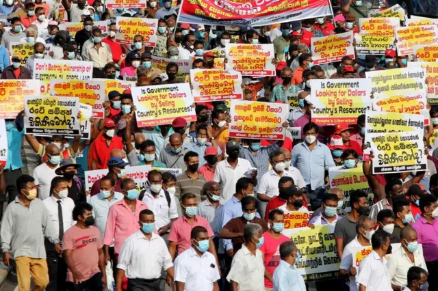 Sri Lankan supporters of the opposition People's Liberation Front (JVP) shout slogans during a protest against the agreement with India to develop the Trincomalee oil tank farm project, in Colombo on January 19, 2022.