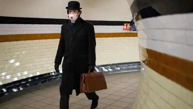 Commuter on the tube wearing face mask