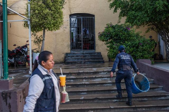 A municipal police officer walks into the local police station in Acatlán, Puebla