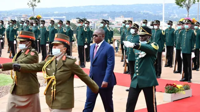 President of Guinea Bissau Umaro Sissoco Embaló inspecting the guard of honour. There are people dressed in military uniform around him.