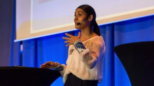 Izabela Tiberiade speaking at an event