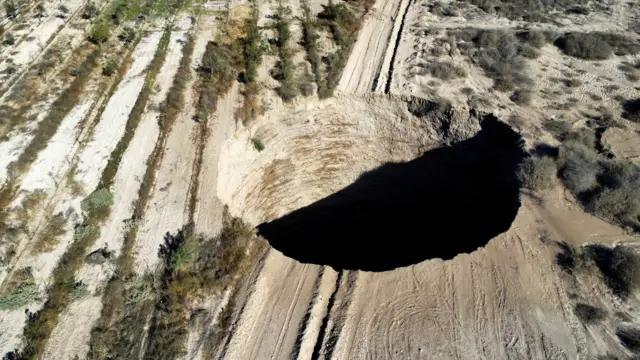 FILE PHOTO: A sinkhole is exposed at a mining zone close to Tierra Amarilla town, in Copiapo, Chile, August 1, 2022. REUTERS/Johan Godoy/File Photo