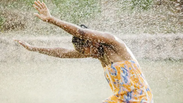 Young woman dey happily enjoy rain