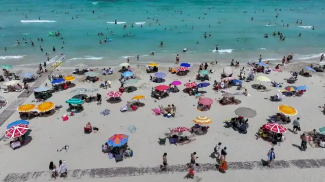 An aerial view of the Ilica Beach as people swim and sunbathe at Cesme district of Izmir