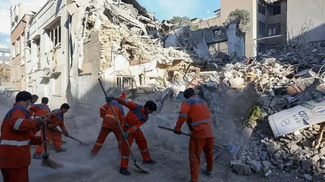 کارگران ایرانی در حال پاکسازی محل حملات اسرائیل و آمریکا هستند؛ حملاتی که بنا بر گزارش رسانههای محلی، کنیسه رفینیا و ساختمانهای مسکونی اطراف آن را در تهران در تاریخ ۷ آوریل ۲۰۲۶ تخریب کرده است.