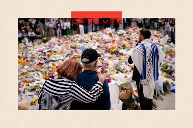 People visit a memorial at Bondi Pavilion before a candlelight vigil at Bondi Beach
