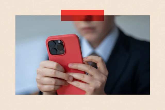 Un écolier regarde l'écran d'un téléphone